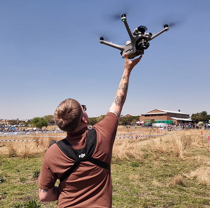 Drone operator hand-launching an enterprise drone at an outdoor event